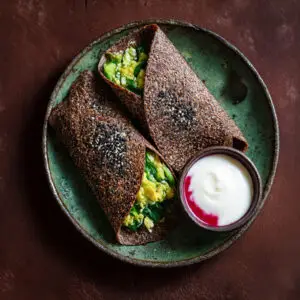 High-protein ragi and oats breakfast wrap filled with avocado and served with yogurt dip